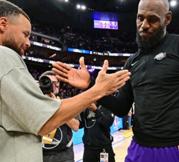 LeBron James #23 of the Los Angeles Lakers and Stephen Curry #30 of the Golden State Warriors high five after a game at Chase Center.
