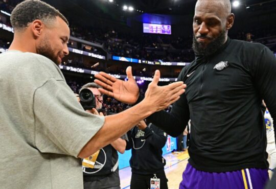 LeBron James #23 of the Los Angeles Lakers and Stephen Curry #30 of the Golden State Warriors high five after a game at Chase Center.