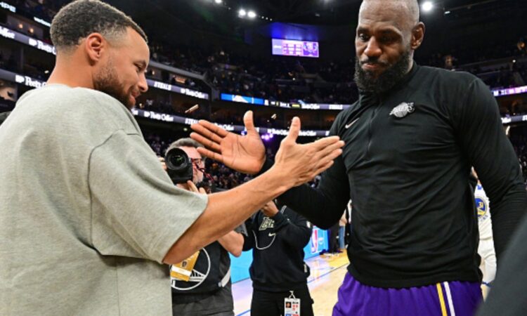 LeBron James #23 of the Los Angeles Lakers and Stephen Curry #30 of the Golden State Warriors high five after a game at Chase Center.