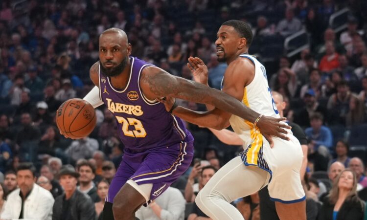 Los Angeles Lakers forward LeBron James drives with the ball against Golden State Warriors guard De'Anthony Melton in the first quarter at Chase Center.