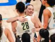 Dallas Wings guard Paige Bueckers embraces center Li Yueru as teammates celebrate a 2026 WNBA win over the Chicago Sky