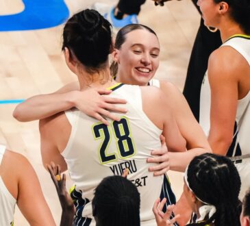 Dallas Wings guard Paige Bueckers embraces center Li Yueru as teammates celebrate a 2026 WNBA win over the Chicago Sky