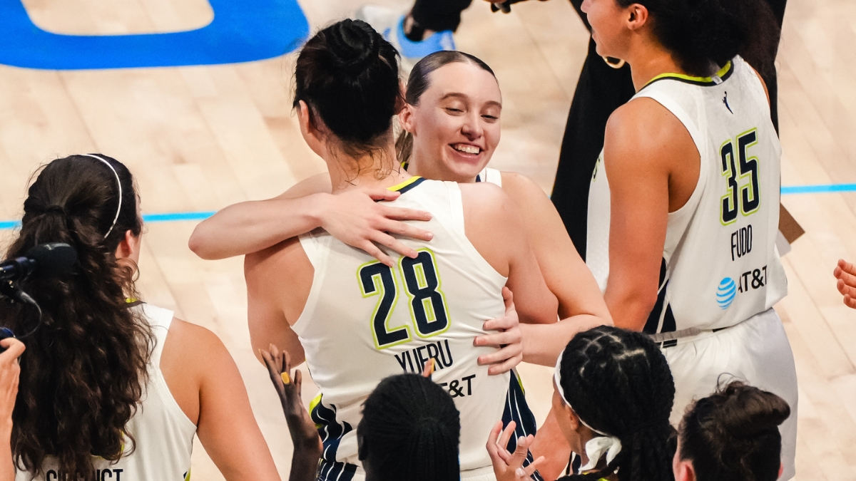 Dallas Wings guard Paige Bueckers embraces center Li Yueru as teammates celebrate a 2026 WNBA win over the Chicago Sky
