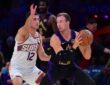 Los Angeles Lakers guard Luke Kennard controls the ball while defended by Phoenix Suns guard Collin Gillespie during a game at Crypto.com Arena