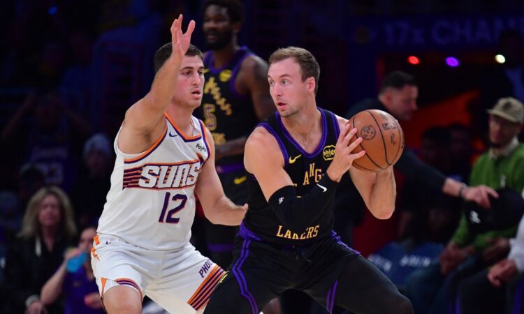 Los Angeles Lakers guard Luke Kennard controls the ball while defended by Phoenix Suns guard Collin Gillespie during a game at Crypto.com Arena