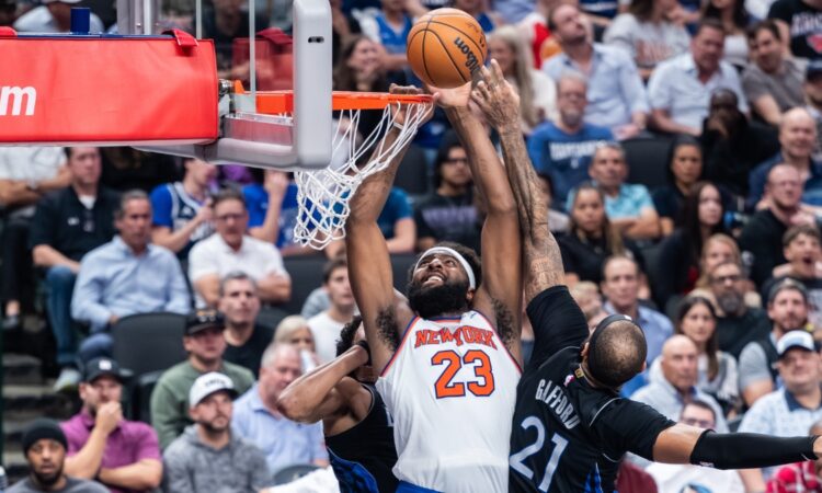 New York Knicks center Mitchell Robinson goes up to dunk against Dallas Mavericks center Daniel Gafford at American Airlines Center.