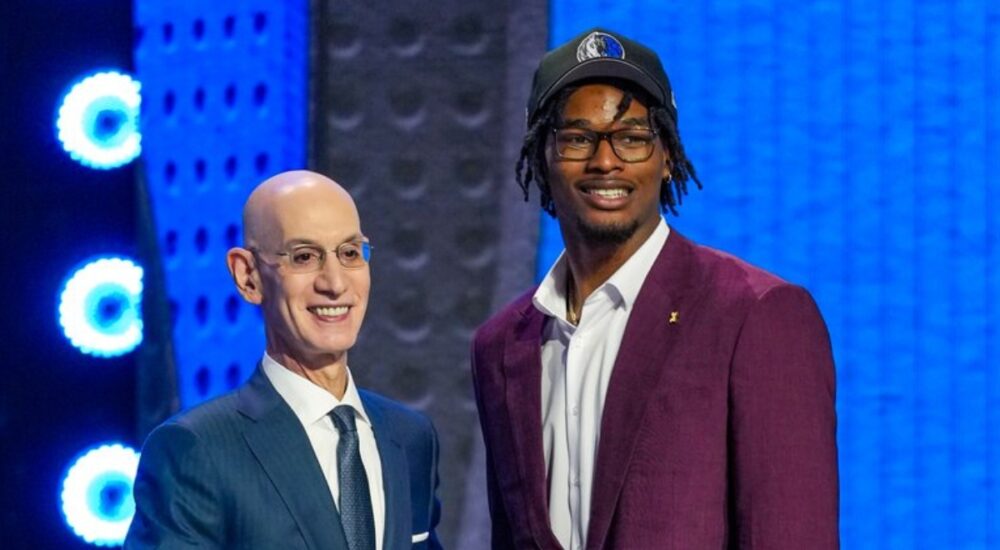 Morez Johnson Jr. wears a Dallas Mavericks cap and shakes hands with NBA Commissioner Adam Silver on stage after being selected No. 9 in the 2026 NBA Draft.