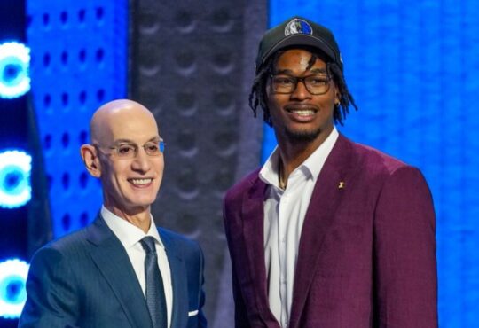 Morez Johnson Jr. wears a Dallas Mavericks cap and shakes hands with NBA Commissioner Adam Silver on stage after being selected No. 9 in the 2026 NBA Draft.