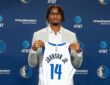 Morez Johnson Jr. holds his No. 14 Dallas Mavericks jersey at his introductory press conference