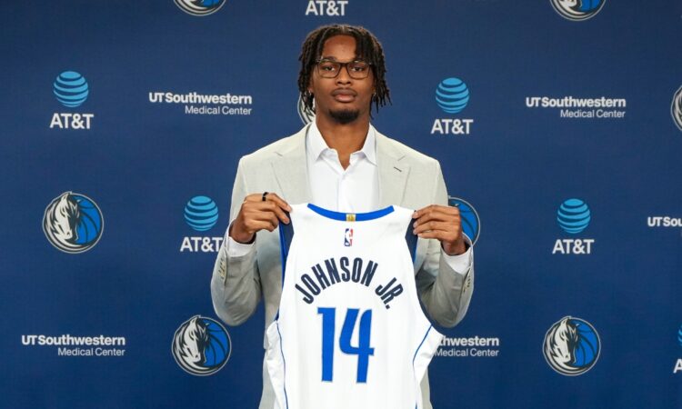 Morez Johnson Jr. holds his No. 14 Dallas Mavericks jersey at his introductory press conference