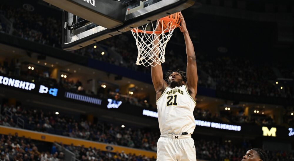 Morez Johnson Jr. throws down a two-handed dunk in a white Michigan No. 21 jersey during the 2026 NCAA Tournament