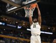 Morez Johnson Jr. throws down a two-handed dunk in a white Michigan No. 21 jersey during the 2026 NCAA Tournament