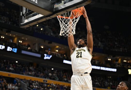 Morez Johnson Jr. throws down a two-handed dunk in a white Michigan No. 21 jersey during the 2026 NCAA Tournament