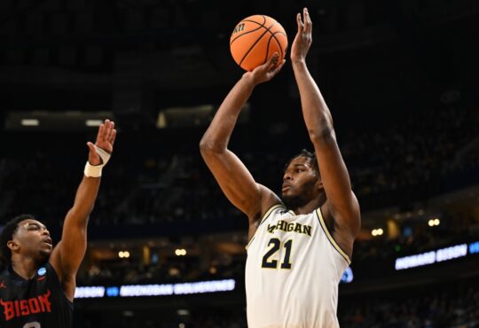 Morez Johnson Jr. rises for a jump shot in a white Michigan No. 21 jersey over a Howard defender during the 2026 NCAA Tournament