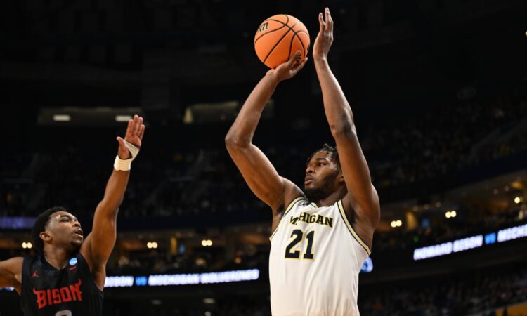 Morez Johnson Jr. rises for a jump shot in a white Michigan No. 21 jersey over a Howard defender during the 2026 NCAA Tournament