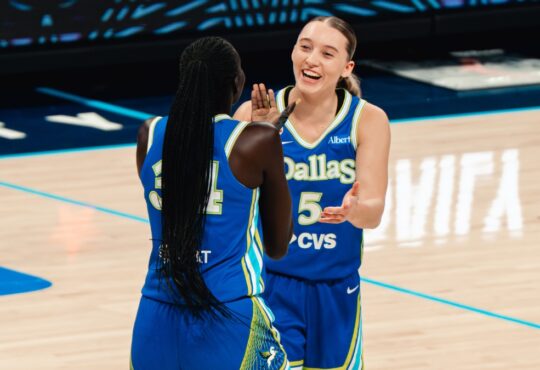 Dallas Wings guard Paige Bueckers celebrates with forward Awak Kuier during a WNBA game against the Las Vegas Aces at College Park Center in Arlington, Texas, on June 15, 2026.