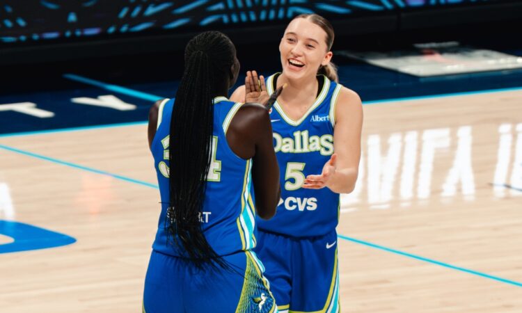 Dallas Wings guard Paige Bueckers celebrates with forward Awak Kuier during a WNBA game against the Las Vegas Aces at College Park Center in Arlington, Texas, on June 15, 2026.