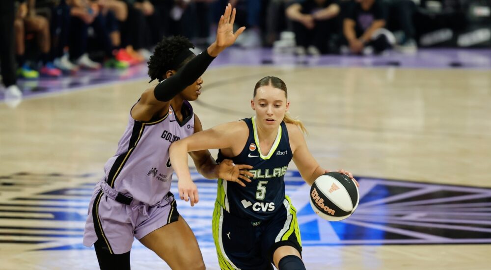 Dallas Wings guard Paige Bueckers, No. 5, drives the ball to her right against a Golden State Valkyries defender at Chase Center.