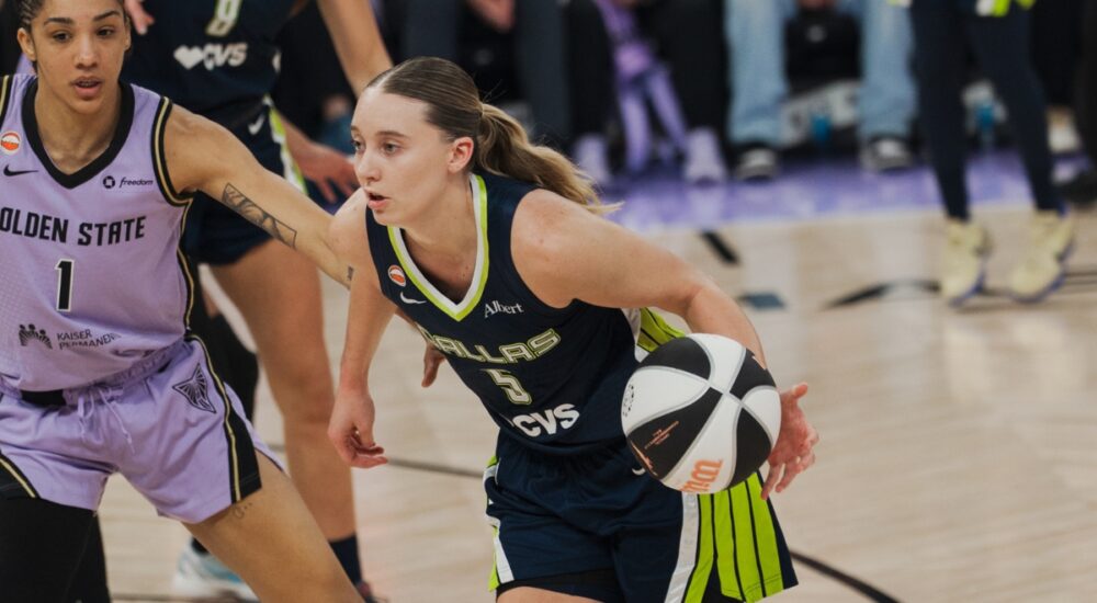 Dallas Wings guard Paige Bueckers drives past Golden State Valkyries forward Gabby Williams during a 2026 WNBA game