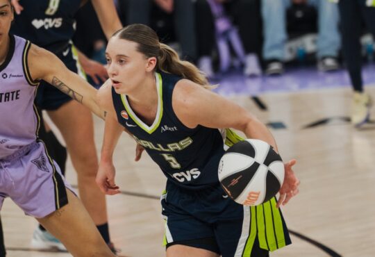 Dallas Wings guard Paige Bueckers drives past Golden State Valkyries forward Gabby Williams during a 2026 WNBA game