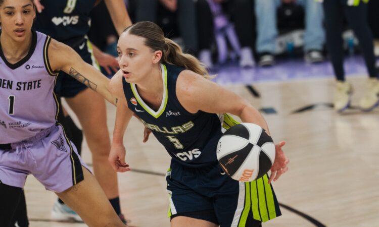 Dallas Wings guard Paige Bueckers drives past Golden State Valkyries forward Gabby Williams during a 2026 WNBA game