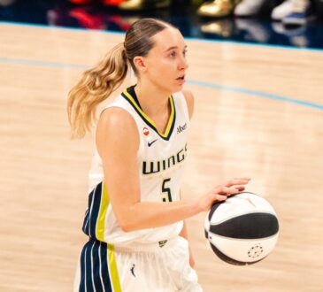 Paige Bueckers brings the ball up the court in a white Dallas Wings home uniform against the Phoenix Mercury on June 11, 2026