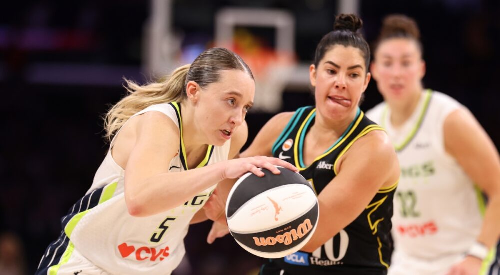 Paige Bueckers of the Dallas Wings protects the ball against Kelsey Plum of the Los Angeles Sparks at Crypto.com Arena.