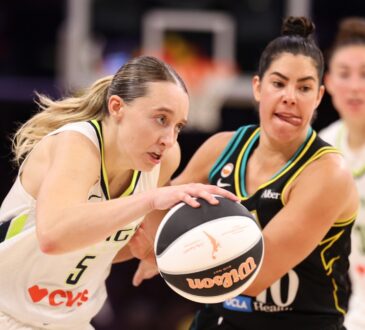 Paige Bueckers of the Dallas Wings protects the ball against Kelsey Plum of the Los Angeles Sparks at Crypto.com Arena.