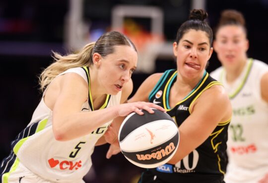 Paige Bueckers of the Dallas Wings protects the ball against Kelsey Plum of the Los Angeles Sparks at Crypto.com Arena.