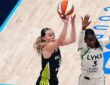 Dallas Wings guard Paige Bueckers rises for a jump shot over Minnesota Lynx guard Maya Caldwell during a WNBA game.