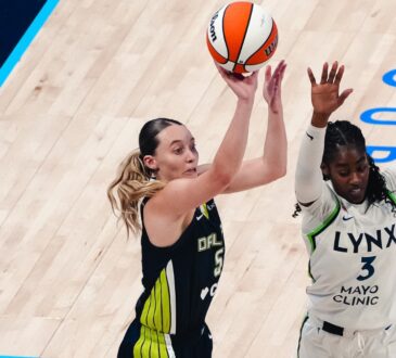 Dallas Wings guard Paige Bueckers rises for a jump shot over Minnesota Lynx guard Maya Caldwell during a WNBA game.