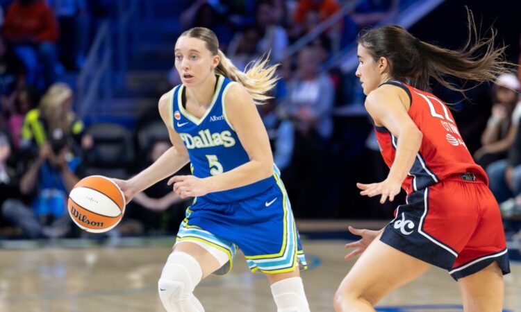 Dallas Wings guard Paige Bueckers dribbles while guarded by Washington Mystics guard Sonia Citron at College Park Center.