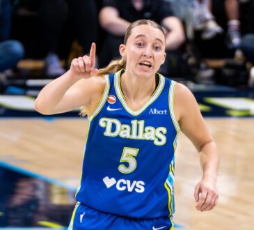 Paige Bueckers gestures in a blue Dallas Wings uniform near teammate Jessica Shepard during a game against the Atlanta Dream on May 12, 2026