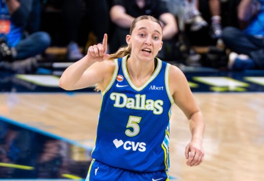 Paige Bueckers gestures in a blue Dallas Wings uniform near teammate Jessica Shepard during a game against the Atlanta Dream on May 12, 2026