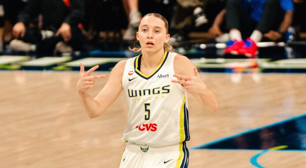 Paige Bueckers celebrates after a basket in a white Dallas Wings home uniform against the Phoenix Mercury on June 11, 2026
