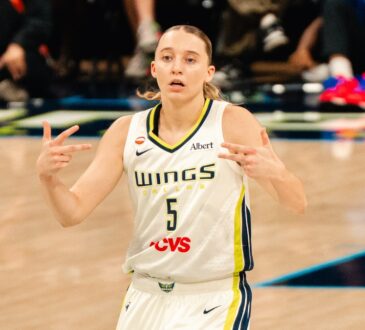 Paige Bueckers celebrates after a basket in a white Dallas Wings home uniform against the Phoenix Mercury on June 11, 2026