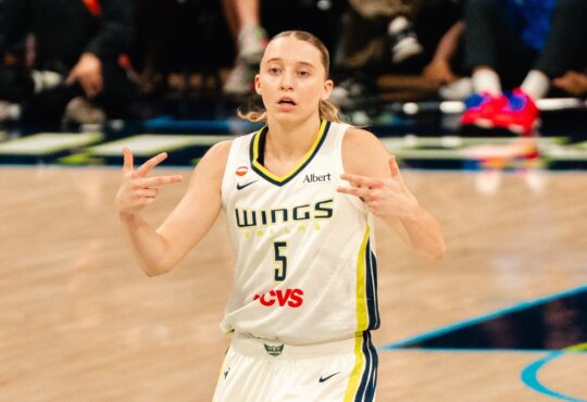 Paige Bueckers celebrates after a basket in a white Dallas Wings home uniform against the Phoenix Mercury on June 11, 2026