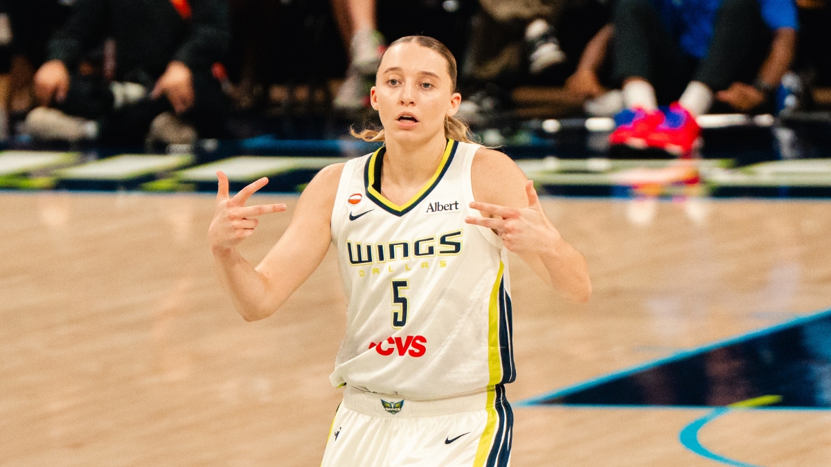 Paige Bueckers celebrates after a basket in a white Dallas Wings home uniform against the Phoenix Mercury on June 11, 2026