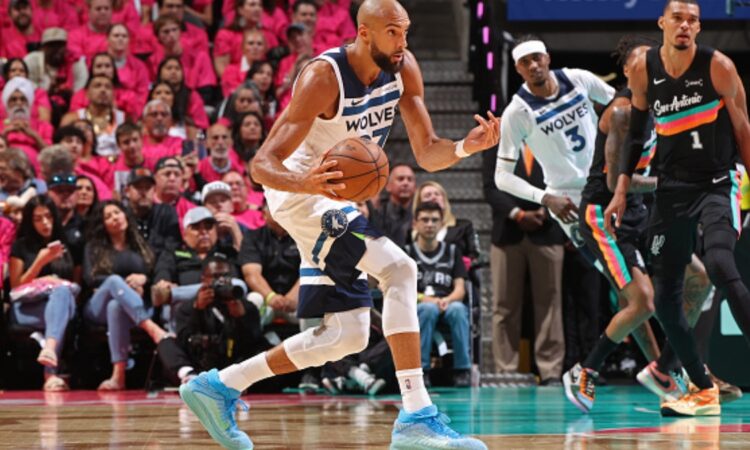 Rudy Gobert #27 of the Minnesota Timberwolves handles the ball against the San Antonio Spurs during Game 1 of the Western Conference Semifinals at Frost Bank Center.