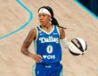 Dallas Wings guard Sug Sutton brings the ball up the court during her WNBA debut against the Las Vegas Aces at College Park Center in Arlington, Texas, on June 15, 2026.