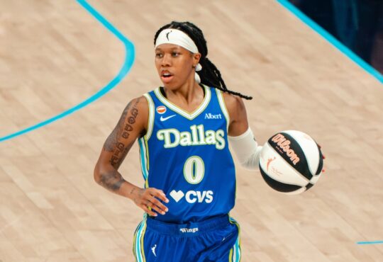 Dallas Wings guard Sug Sutton brings the ball up the court during her WNBA debut against the Las Vegas Aces at College Park Center in Arlington, Texas, on June 15, 2026.
