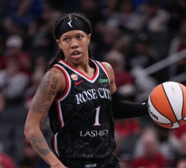Sug Sutton dribbles up the court in a Portland Fire jersey during a game against the Indiana Fever