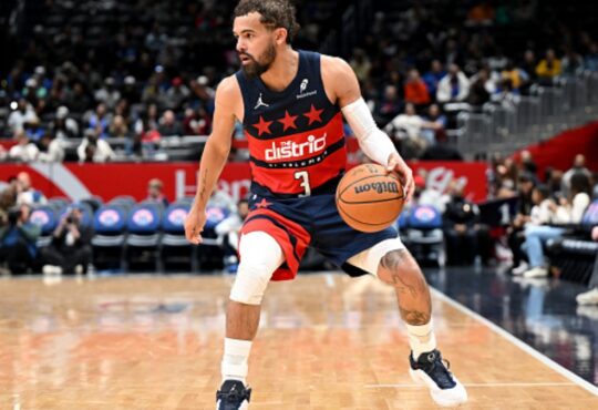 Trae Young #3 of the Washington Wizards handles the ball against the Golden State Warriors at Capital One Arena.