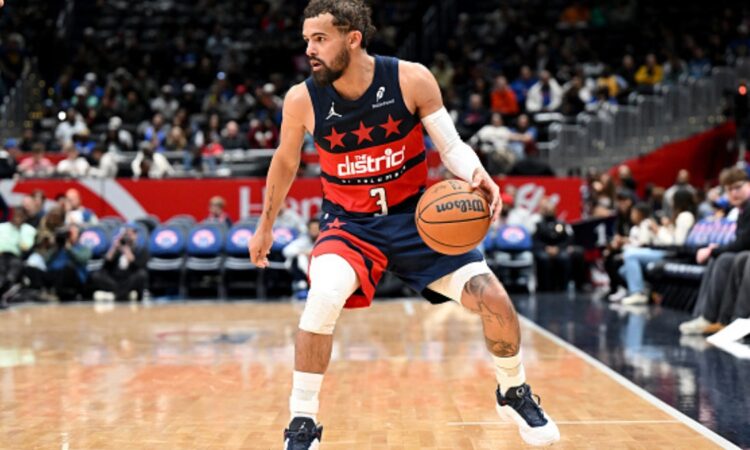 Trae Young #3 of the Washington Wizards handles the ball against the Golden State Warriors at Capital One Arena.