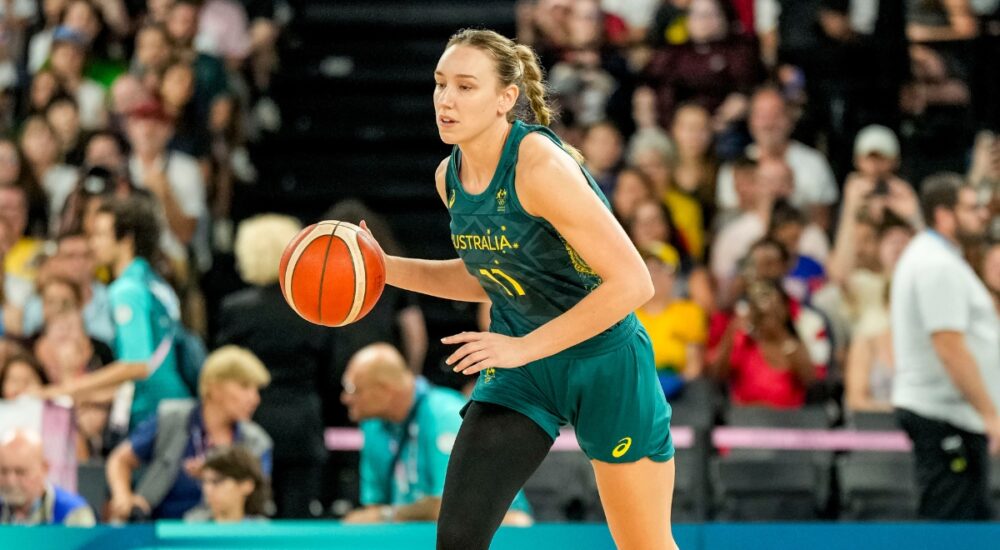 Australia forward Alanna Smith dribbles up the court in a green Opals uniform during the Paris 2024 Olympic semifinal against the United States.