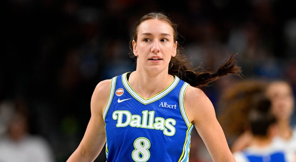 Dallas Wings forward Alanna Smith wears a blue No. 8 jersey while walking up the court during a game against the Chicago Sky at American Airlines Center.