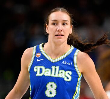 Dallas Wings forward Alanna Smith wears a blue No. 8 jersey while walking up the court during a game against the Chicago Sky at American Airlines Center.