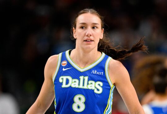 Dallas Wings forward Alanna Smith wears a blue No. 8 jersey while walking up the court during a game against the Chicago Sky at American Airlines Center.