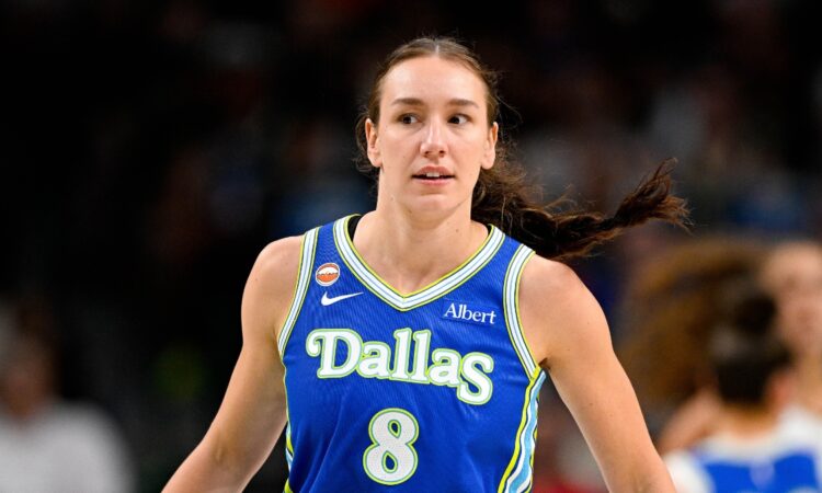 Dallas Wings forward Alanna Smith wears a blue No. 8 jersey while walking up the court during a game against the Chicago Sky at American Airlines Center.