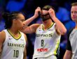 Alanna Smith of the Dallas Wings adjusts her protective mask after colliding with Gabriela Jaquez of the Chicago Sky during their WNBA game on June 20, 2026